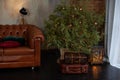 Christmas room interior. Stylish interior of living room with Christmas fir tree and brown sofa. Beautiful decorated room for Xmas Royalty Free Stock Photo