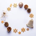 Christmas round frame with golden ornaments, painted snowflakes, pine cones, confetti on grey background, copy space Royalty Free Stock Photo