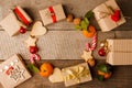 Christmas composition of various gift boxes wrapped in craft paper and decorated with satin red gold ribbons and holiday sweetness Royalty Free Stock Photo