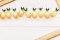 Christmas rustic background with string lights as pineapples golden colored. Festive decoration, New Year fairy garland Royalty Free Stock Photo