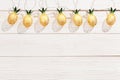 Christmas rustic background with string lights as pineapples golden colored. Festive decoration, New Year fairy garland Royalty Free Stock Photo