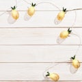 Christmas rustic background with string lights as pineapples golden colored. Festive decoration, New Year fairy garland. Royalty Free Stock Photo