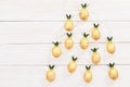 Christmas rustic background with string lights as pineapples golden colored. Christmas tree from New Year fairy garland. Royalty Free Stock Photo