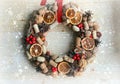 Christmas in a rustic style. Handmade decor. Christmas wreath on the background of old boards. Festive mood.