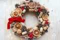 Christmas in a rustic style. Handmade decor. Christmas wreath on the background of old boards. Festive mood.