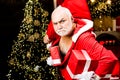 Christmas safety from burglars and home security. Funny bad Santa Claus with gift, bag with presents. Criminal christmas