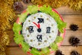 The Christmas salad rice olives greens peas - concept New year clock face, midnight, brown wooden background spruce Royalty Free Stock Photo