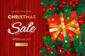 Christmas Sale banner. Realistic fir-tree branches with berries and red gift box on wooden red background. Vector illustration for Royalty Free Stock Photo