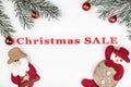 Christmas sale banner on white background with evergreen branches, handmade santa and tree toys decorations. Royalty Free Stock Photo