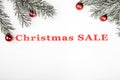 Christmas sale banner on white background with evergreen branches and tree toys decorations. Royalty Free Stock Photo