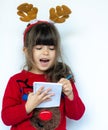 Christmas sale. Beautiful shocked kid holding pen and make a shopping list for New year sales.