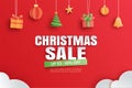 Christmas sale with gifts and elements hanging on red background banner in paper art style Royalty Free Stock Photo