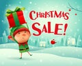 Christmas Sale! Little elf holds up gift present in Christmas sn