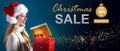 Christmas sale message with woman opening a gift box Royalty Free Stock Photo