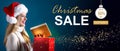 Christmas sale message with woman opening a gift box Royalty Free Stock Photo