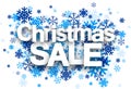 Christmas sale paper sign over snowflakes