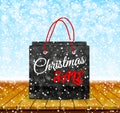 Christmas sale. Shoping paper bag on wood table top