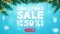 Christmas sale, up to 50% off, blue discount banner with frame of Christmas tree branches decorated with garland, button. Royalty Free Stock Photo