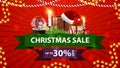 Christmas sale, up to 30% off, red discount banner with ribbons, snow globe, gift with Santa Claus hat, candles, Christmas tree Royalty Free Stock Photo