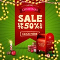 Christmas sale, up to 50% off, square green and red discount banner with large red ribbon with offer, garlands, candle Royalty Free Stock Photo