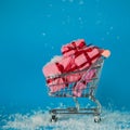 Christmas sales. Buying gifts for the new year, the concept. The shopping cart is full of gift boxes Royalty Free Stock Photo