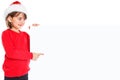 Christmas Santa Claus child kid girl pointing looking empty banner copyspace Royalty Free Stock Photo