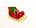 Christmas Santa Claus sleigh with skids decorated with holly plant, ornament and bells with red gift box with bow. Realistic Royalty Free Stock Photo