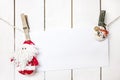 Christmas Santa Claus and snowman clothespin holding white paper Royalty Free Stock Photo