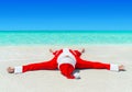 Christmas Santa Claus sunbathing at tropical ocean beach in wate Royalty Free Stock Photo