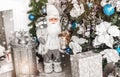 Christmas Santa Claus under Christmas tree with decoration, lantern, snow, blurred, sparking, glowing.