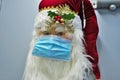 Christmas 2020 santa clause wearing mask PPE personal protection equipment to protect against covid-19 virus