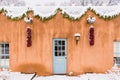 Christmas in Santa Fe, building with red chile ristras and garland