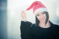 Christmas Santa hat outdoors woman smiling portrait . Smiling happy girl wearing her Santa hat with city urban background Royalty Free Stock Photo