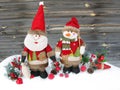 christmas santa snowman decoration winter berries and snow on wooden background Royalty Free Stock Photo