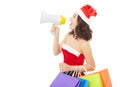 Christmas santa woman using a megaphone with gift bags Royalty Free Stock Photo