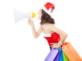 Christmas santa woman using a megaphone with gift bags Royalty Free Stock Photo