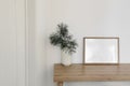 Christmas Scandinavian interior. Minimal winter artistic composition. Blank horizontal wooden picture frame mockup. Pine Royalty Free Stock Photo