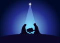 Christmas scene of baby Jesus in the manger with Mary and Joseph in silhouette Royalty Free Stock Photo