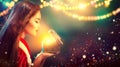 Christmas scene. Beauty brunette young woman in party costume opening gift box Royalty Free Stock Photo