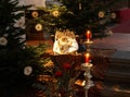 christmas scene with crib and baby Jesus in it surrounded by candles and christmas trees Royalty Free Stock Photo