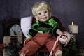 Christmas scene with doll holding candy cane and gifts