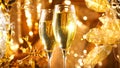 Christmas scene. Flute with sparkling champagne over holiday golden bokeh blinking background Royalty Free Stock Photo