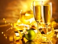 Christmas scene. Holiday champagne over golden glow background. Christmas and New Year celebration. Two flutes with sparkling wine Royalty Free Stock Photo