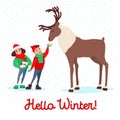 Christmas Scene with Kids. Children Feeding Deer on Winter Holidays. New Year Celebration