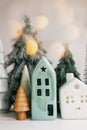 Christmas scene, miniature holiday village. Christmas lights, little houses, trees on white Royalty Free Stock Photo