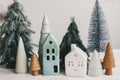 Christmas scene, miniature holiday village. Christmas little houses and trees on white background Royalty Free Stock Photo