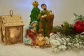 Christmas scene of the Nativity of Jesus, Nativity of Christ, Nativity scene Statuettes decorated in the snow with a fir branch Royalty Free Stock Photo