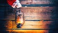 Christmas Scene. Santa Claus Hand Holding Vintage Oil Lamp