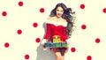 Christmas scene. Santa. Beauty model girl holding gifts Royalty Free Stock Photo