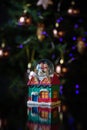 Christmas scene with tree, lights and snow globe. Selective focus on black background Royalty Free Stock Photo